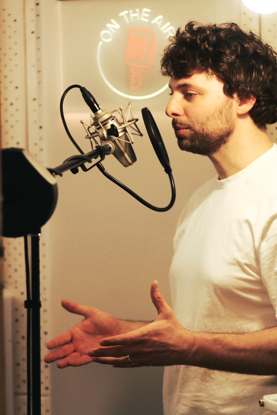 Jonathan Enns bei einer Sprachaufnahme am Neumann-Mikrofon in seinem Tonstudio.